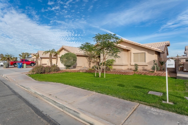 view of front of home featuring a garage and a front yard