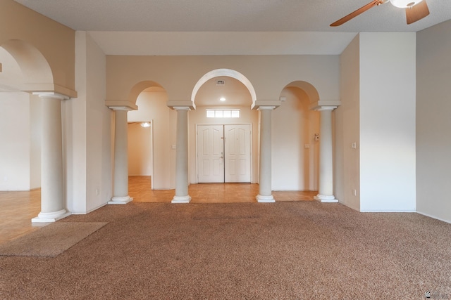 carpeted empty room featuring a textured ceiling and ceiling fan