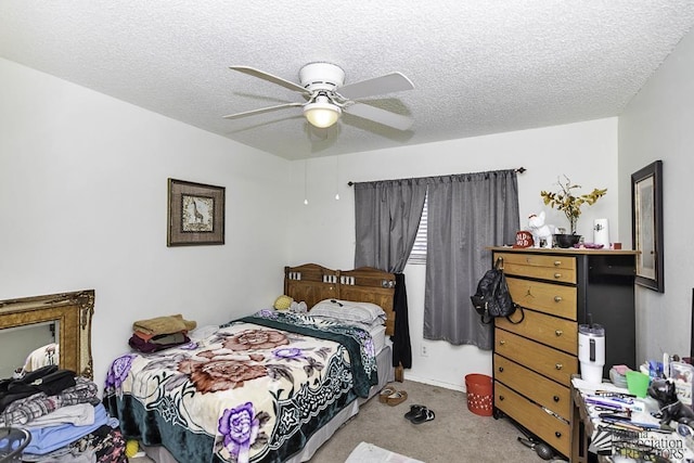 carpeted bedroom featuring ceiling fan and a textured ceiling