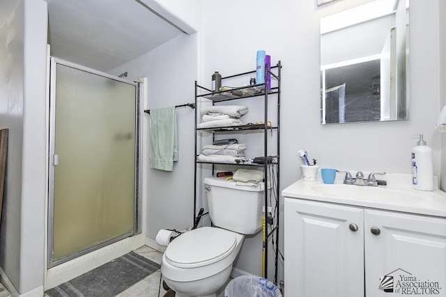 bathroom with vanity, tile patterned flooring, toilet, and walk in shower