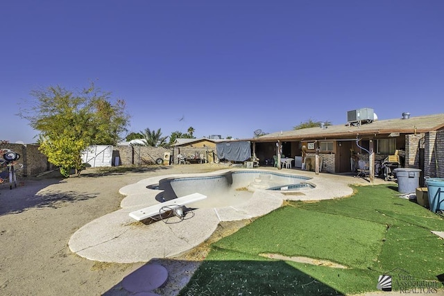 view of swimming pool with a patio and central air condition unit