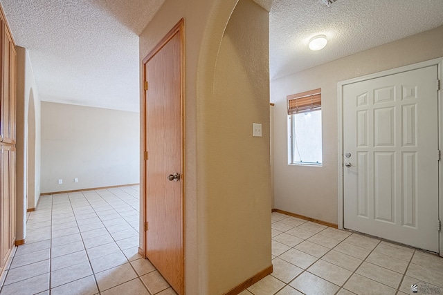 tiled entrance foyer with a textured ceiling