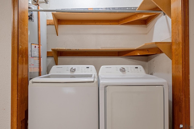 clothes washing area with water heater and washer and dryer