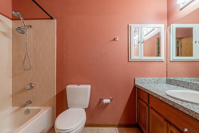 full bathroom featuring tiled shower / bath, tile patterned flooring, vanity, and toilet