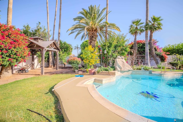 view of swimming pool with a gazebo, a lawn, and a fenced backyard