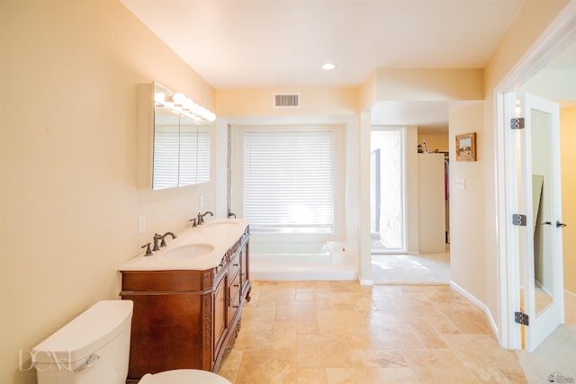 full bathroom with visible vents, a sink, toilet, and double vanity