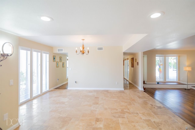 spare room featuring an inviting chandelier, baseboards, visible vents, and recessed lighting