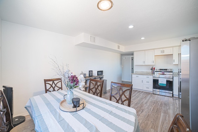 dining room featuring light hardwood / wood-style flooring