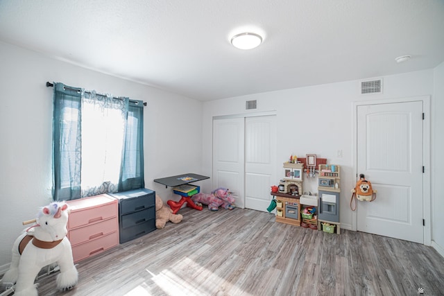 game room with light hardwood / wood-style floors