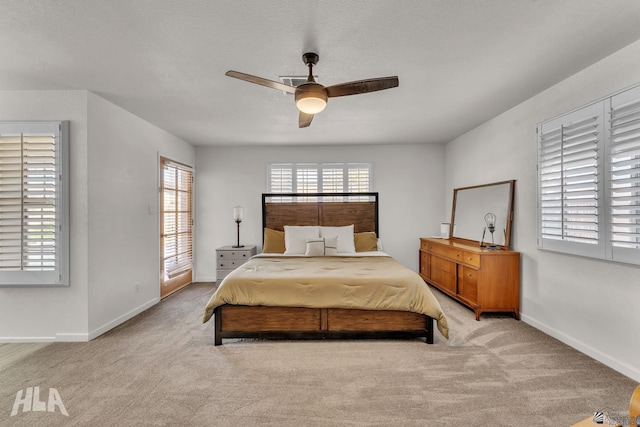 bedroom featuring a ceiling fan, light colored carpet, and baseboards