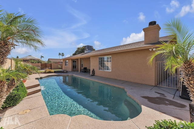 view of swimming pool with central AC unit, a patio area, fence, and a fenced in pool