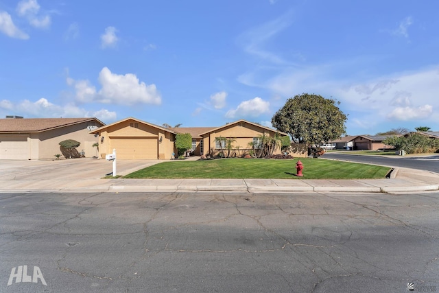 single story home with driveway, a garage, a residential view, a front lawn, and stucco siding