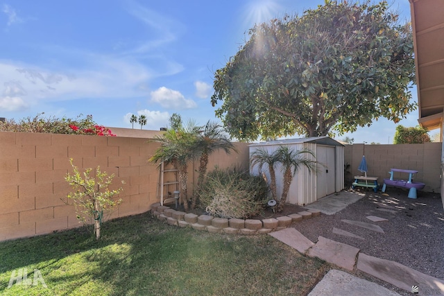 view of yard with a storage shed, an outdoor structure, and a fenced backyard