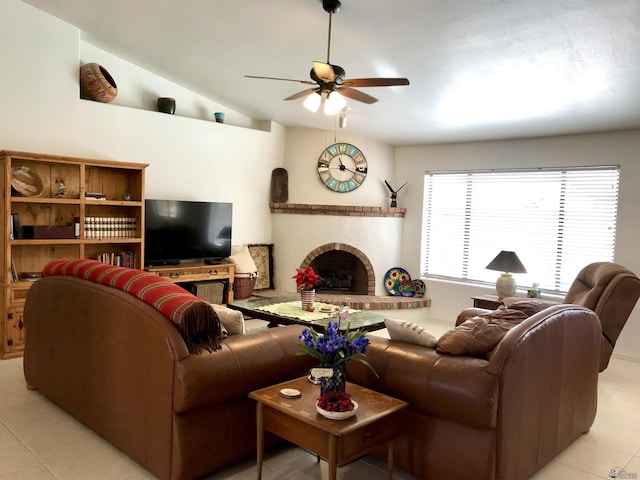 tiled living room with ceiling fan, lofted ceiling, and a brick fireplace