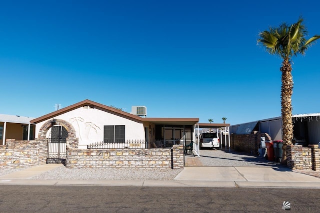 view of front of house with central AC and a carport