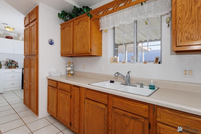 kitchen with sink and light tile patterned floors