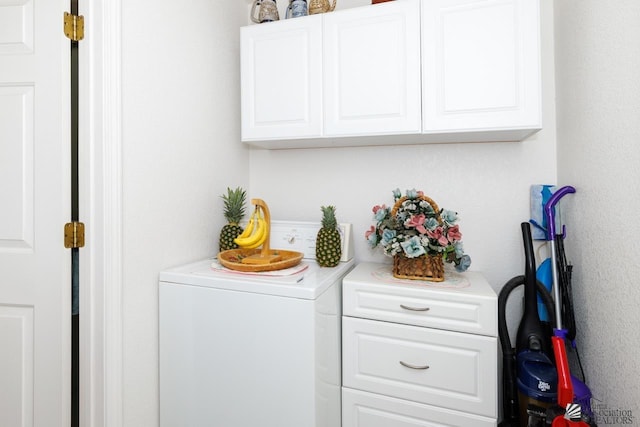 laundry area with cabinets and washer / clothes dryer