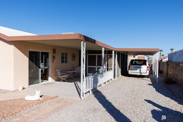 back of property featuring a carport