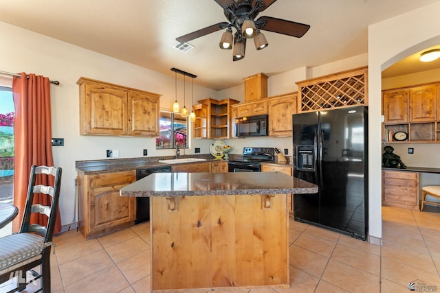 kitchen with black appliances, a center island, light tile patterned flooring, and hanging light fixtures