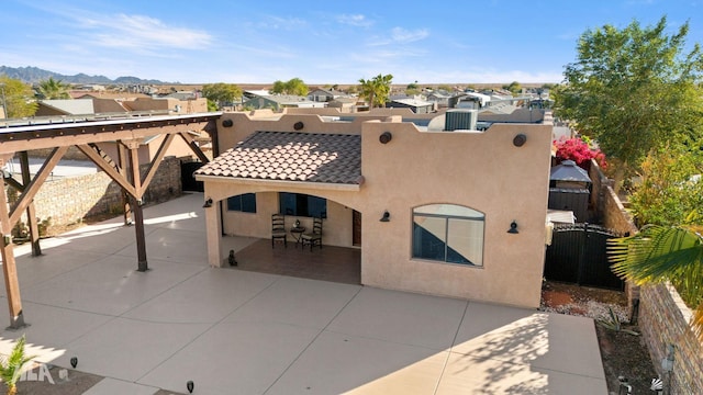 view of front of home with a mountain view and a patio area