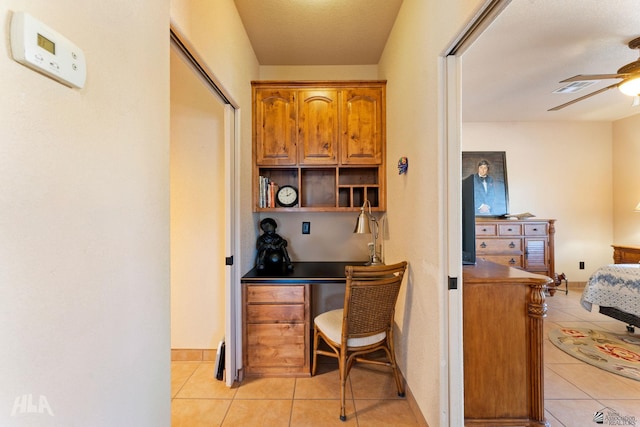 tiled home office with ceiling fan