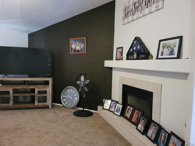 living room with carpet, a fireplace, lofted ceiling, and a textured ceiling