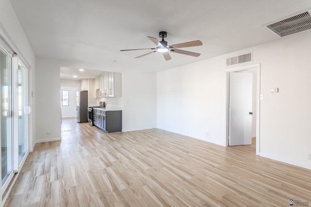 unfurnished living room with ceiling fan and light hardwood / wood-style floors