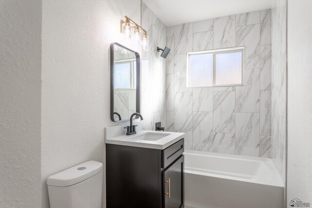 full bathroom with vanity, tiled shower / bath combo, and toilet