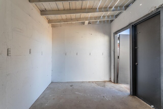 unfurnished room with beamed ceiling and wood ceiling