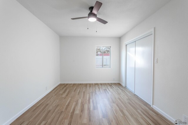 unfurnished bedroom with ceiling fan, light hardwood / wood-style floors, and a closet