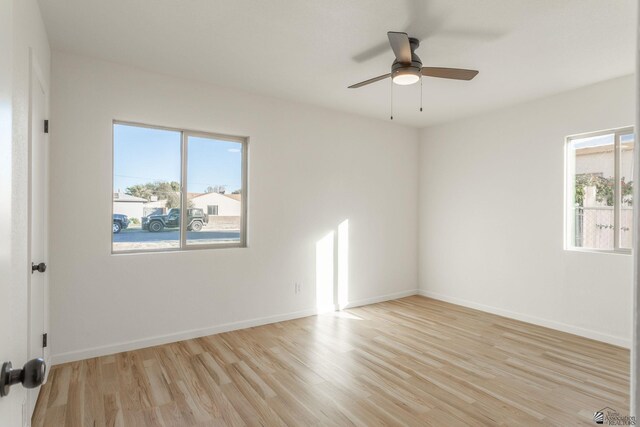 spare room with light hardwood / wood-style floors, plenty of natural light, and ceiling fan