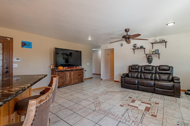 living room with ceiling fan and light tile patterned flooring