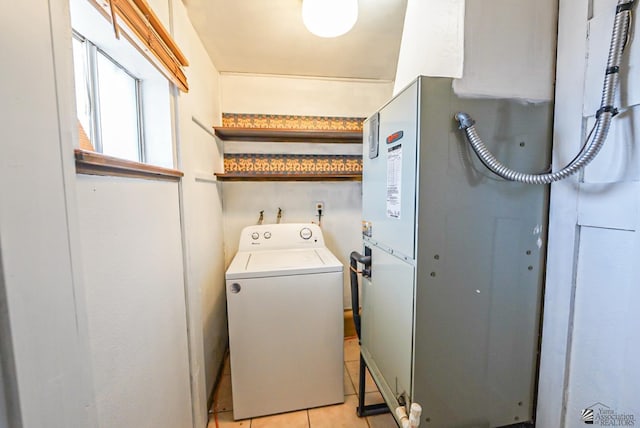 laundry area featuring washer / dryer, laundry area, and light tile patterned flooring