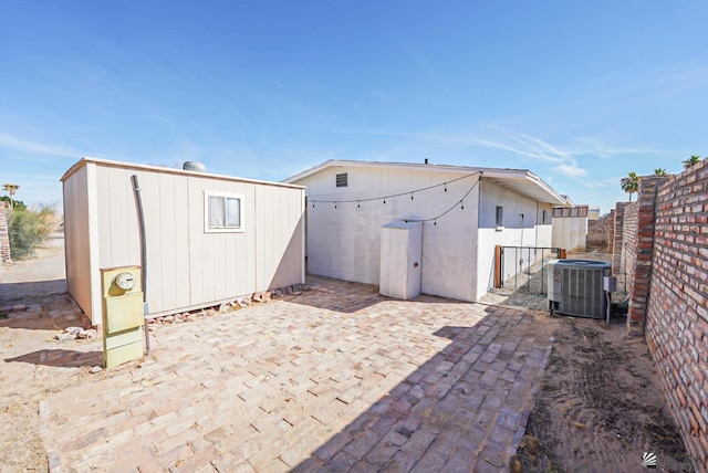 exterior space with central AC unit and fence