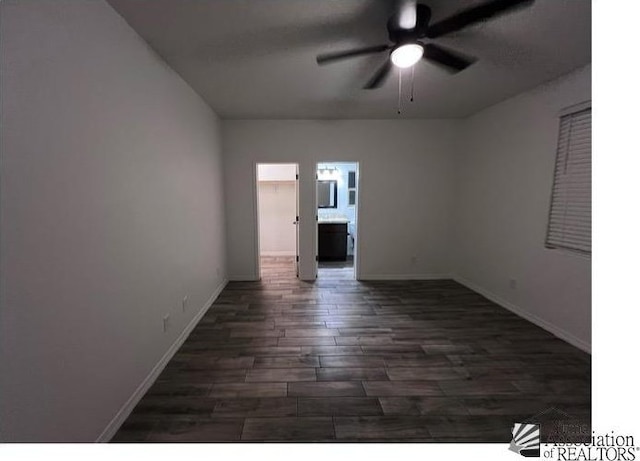 empty room with dark hardwood / wood-style flooring and ceiling fan