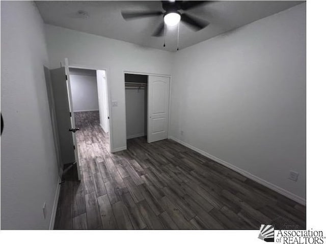 unfurnished bedroom featuring ceiling fan, dark hardwood / wood-style flooring, and a closet