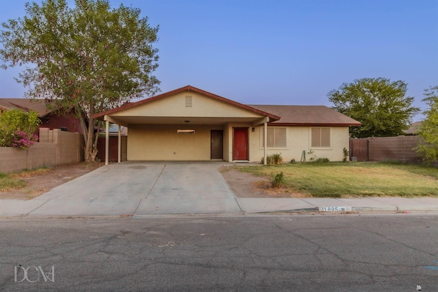 single story home with a front lawn and a carport