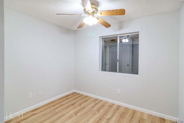 unfurnished room with hardwood / wood-style floors and a textured ceiling