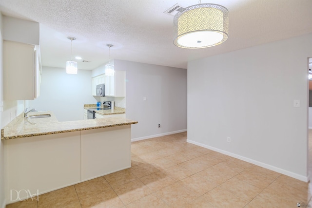 kitchen featuring white cabinetry, sink, stainless steel appliances, kitchen peninsula, and pendant lighting