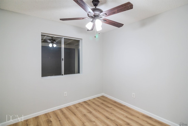 empty room with a textured ceiling, light hardwood / wood-style flooring, and ceiling fan