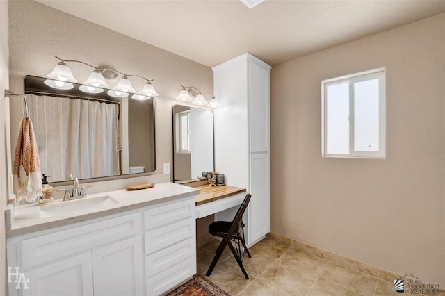 bathroom with tile patterned floors, vanity, and toilet