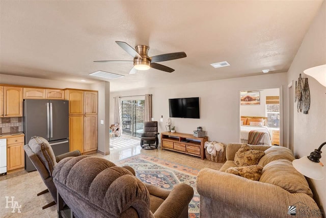 tiled living room with ceiling fan