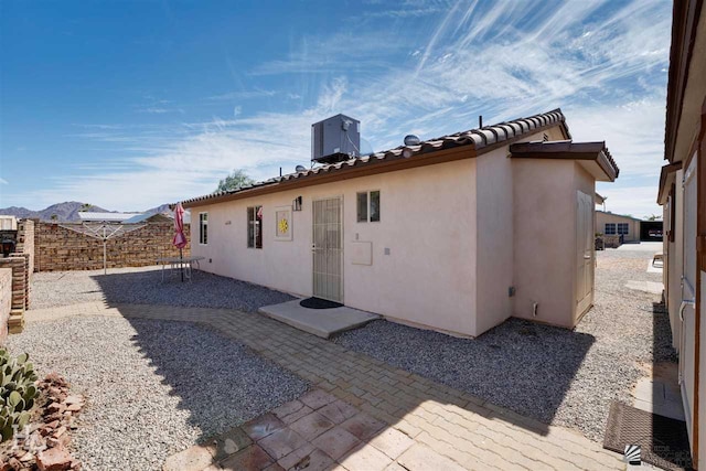 rear view of house with a patio and central air condition unit