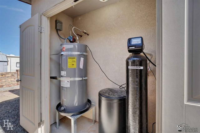 utility room featuring strapped water heater