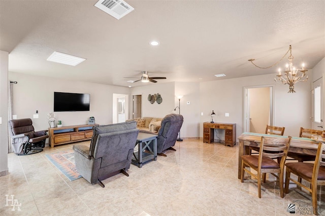 living room with ceiling fan with notable chandelier