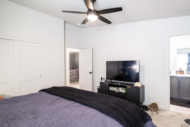 bedroom with baseboards, connected bathroom, ceiling fan, carpet flooring, and a closet