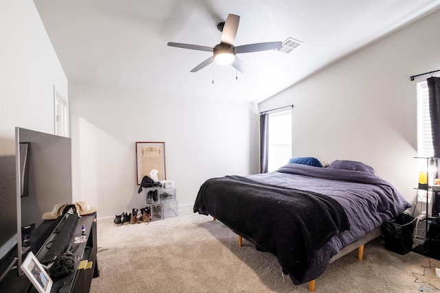 bedroom with a ceiling fan, carpet flooring, visible vents, and baseboards