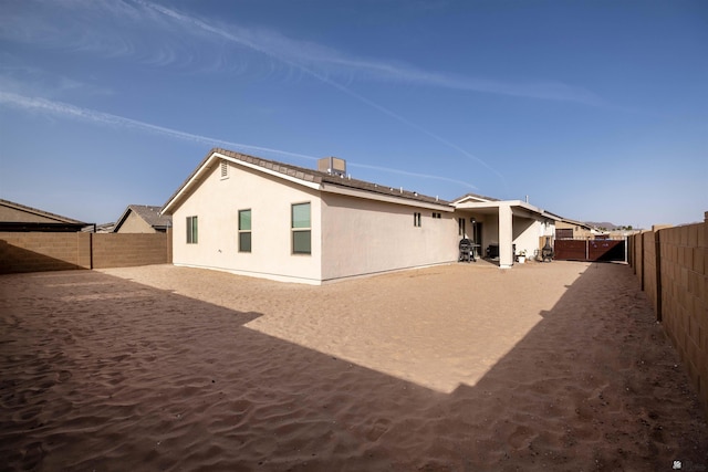 back of property featuring a fenced backyard and stucco siding