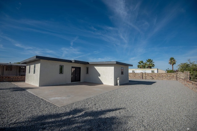 back of house with a patio