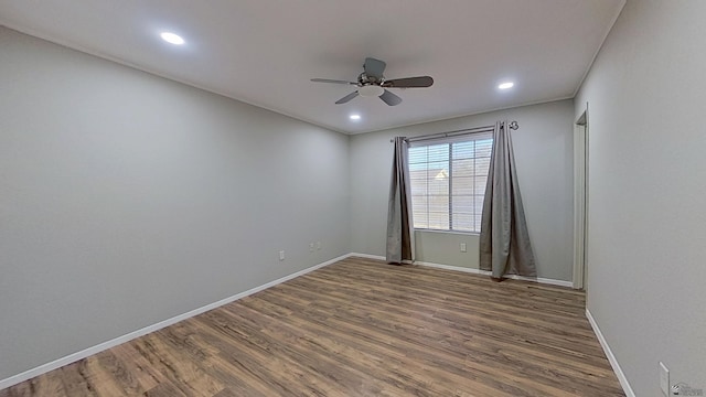 spare room featuring ceiling fan, recessed lighting, wood finished floors, and baseboards